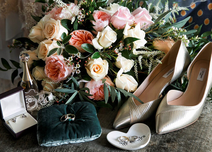 Wedding flowers on chair with shoes and rings