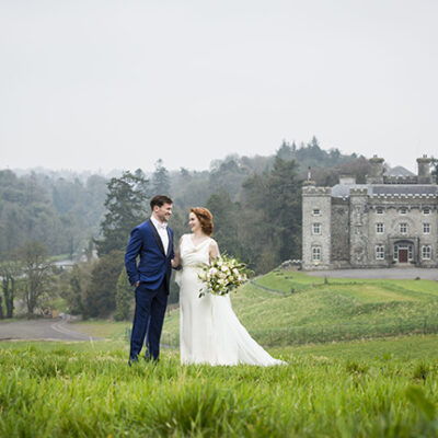 Wedding couple on a hill with Slane in the background