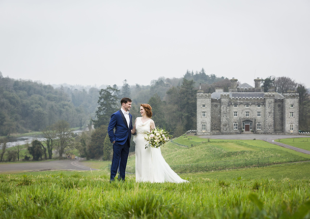 Wedding couple on a hill with Slane in the background