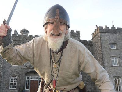 A man dressed as a Viking with a sword drawn