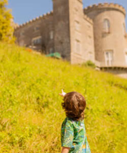 A little boy pointing up at the back of the Castle