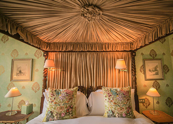 An four poster bed showing the draped fabric