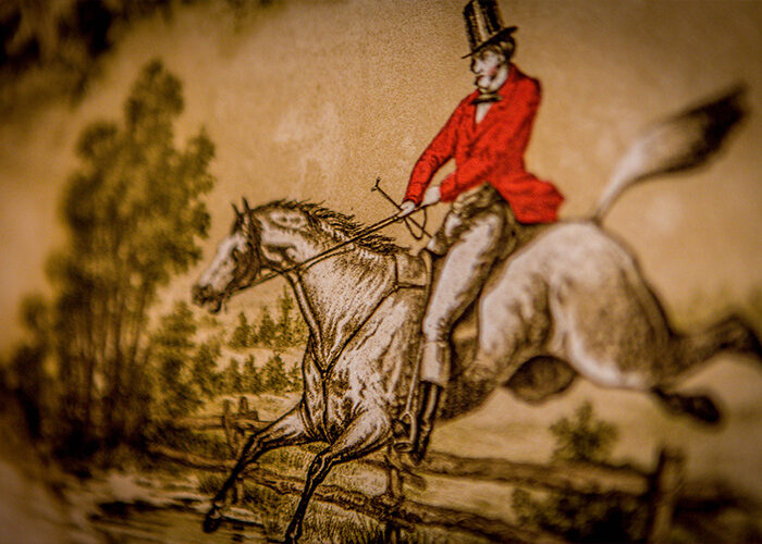 Close up of wallpaper with a fox hunter on a horse