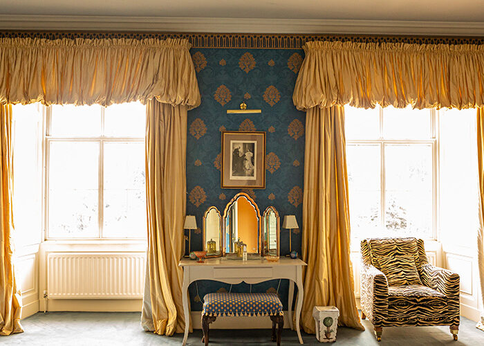 A dressing table between two windows