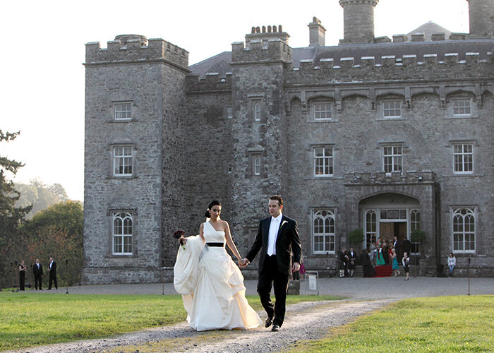A wedding couple walking away from the Castle