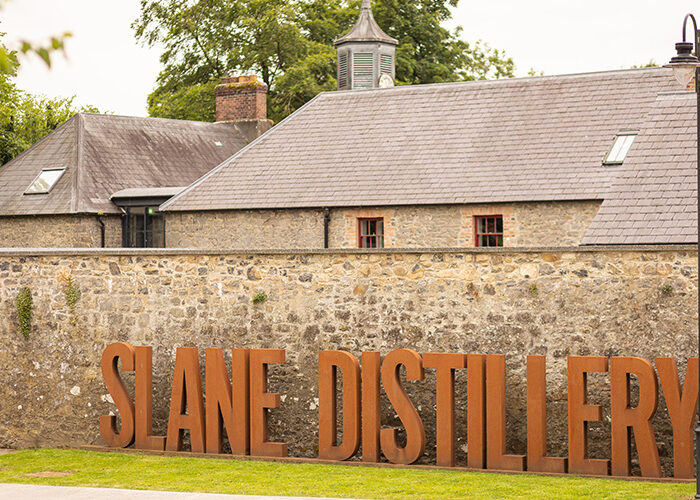 Slane Distillery sign with distillery in the background