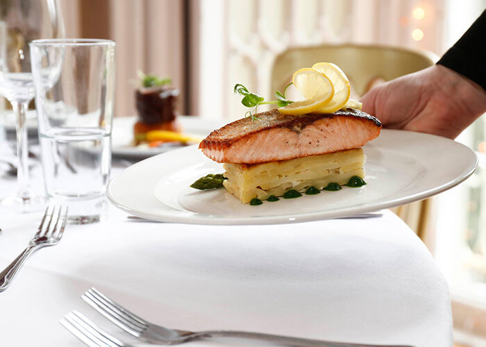 Salmon dinner being placed on table