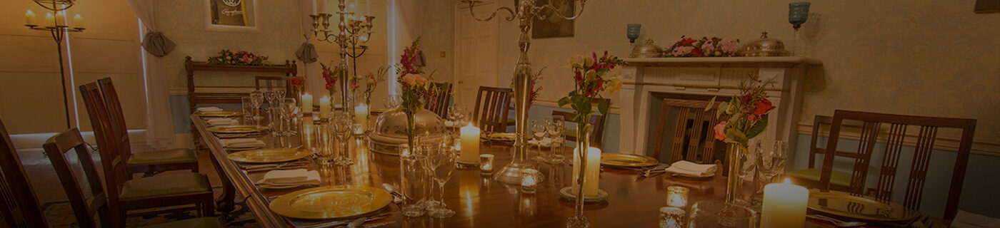A table set for dinner in a drawing room