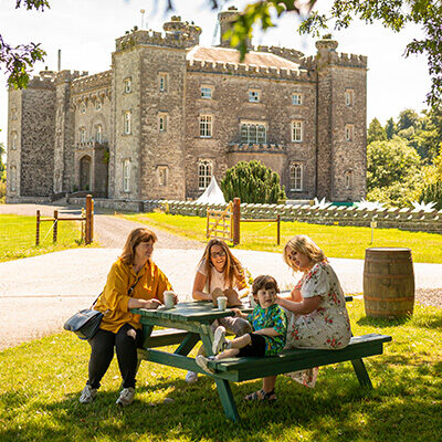 Family sitting outside Slane on picnic bench