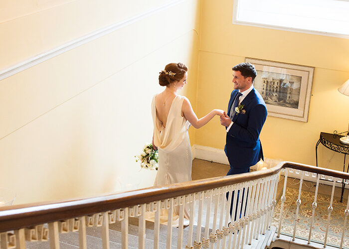 Couple holding hands on staircase