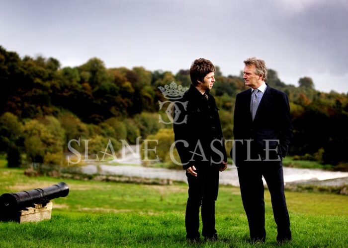 Noel Gallagher talking to Lord Henry in a field