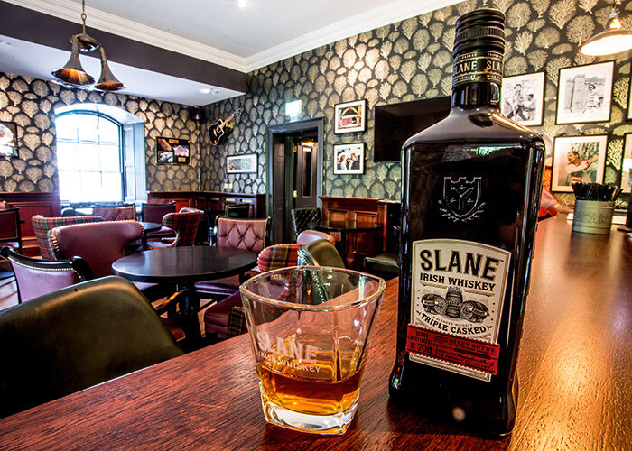 Slane Whiskey and glass on the Bar