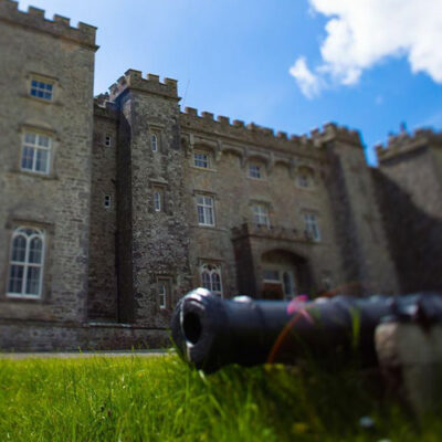 A cannon with Slane Castle in the distance