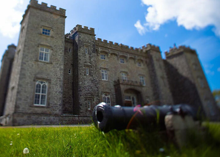 A cannon with Slane Castle in the distance