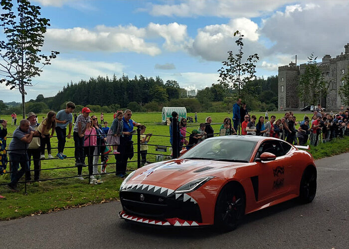 A red sports car on the grounds for the Cannonball Event