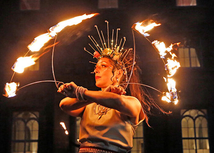 A woman dancing with fire for the Puca Festival