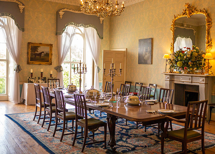 A formal dining room with table set for dinner